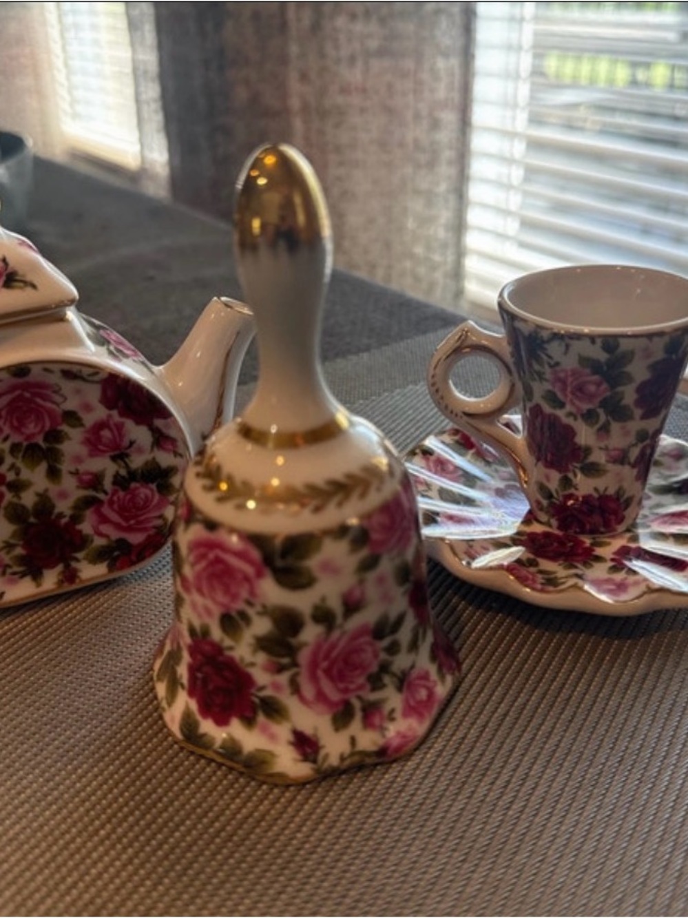 Miniature porcelain tea set features a floral rose chintz pattern